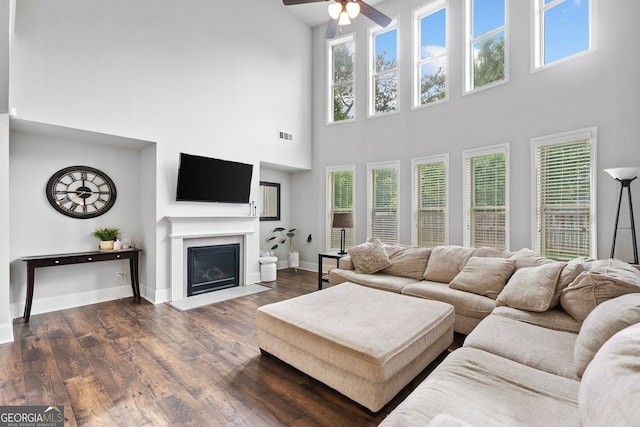 2767 NW Magnolia Creek Dr, Kennesaw, GA 30152 - living area featuring a high ceiling, a ceiling fan, plenty of natural light, dark wood-style flooring, and a fireplace with flush hearth