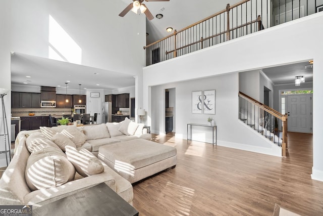 2767 NW Magnolia Creek Dr, Kennesaw, GA 30152 - living room with a ceiling fan, stairway, light wood-type flooring, a towering ceiling, and recessed lighting