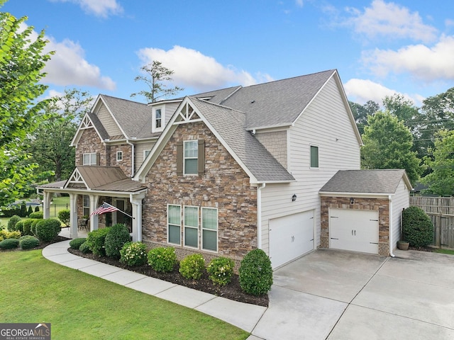 2767 NW Magnolia Creek Dr, Kennesaw, GA 30152 - craftsman-style home with stone siding, driveway, and a shingled roof