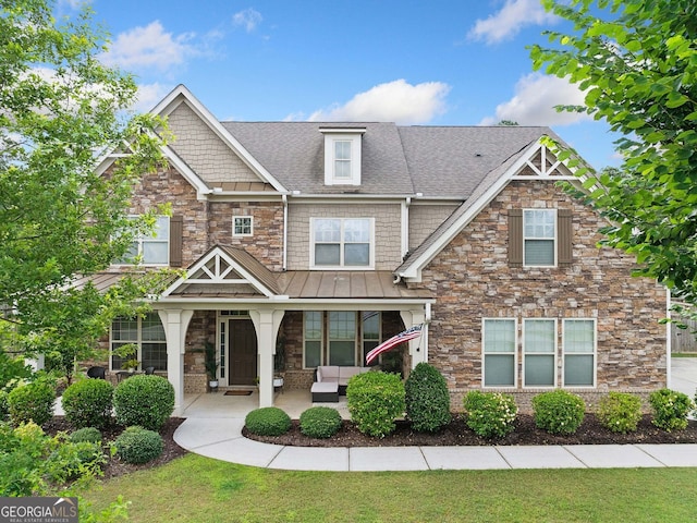 2767 NW Magnolia Creek Dr, Kennesaw, GA 30152 - craftsman-style home with a standing seam roof, stone siding, a shingled roof, and covered porch