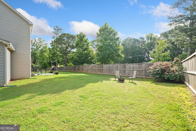 2767 NW Magnolia Creek Dr, Kennesaw, GA 30152 - fenced backyard featuring a fire pit and view of wooded area