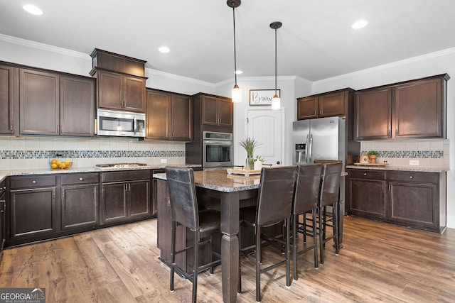2767 NW Magnolia Creek Dr, Kennesaw, GA 30152 - kitchen featuring stainless steel appliances, dark brown cabinets, stone counters, tasteful backsplash, and wood finished floors