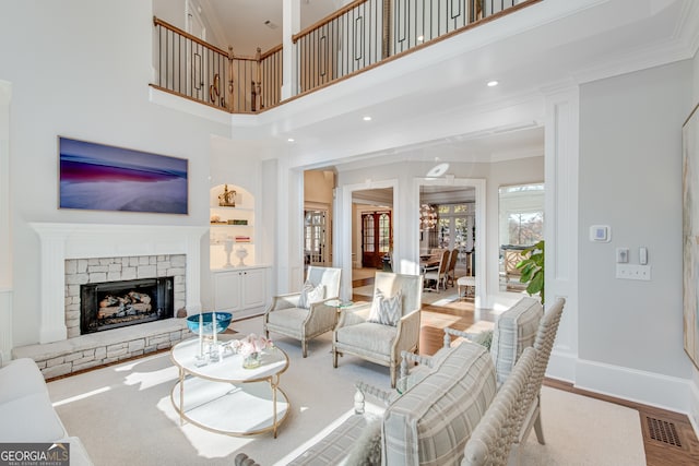 6226 Random Winds Blf, Gainesville, GA 30506 - living room featuring crown molding, a fireplace, wood finished floors, and a high ceiling
