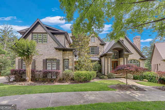 6226 Random Winds Blf, Gainesville, GA 30506 - french country inspired facade with brick siding, stone siding, and a chimney