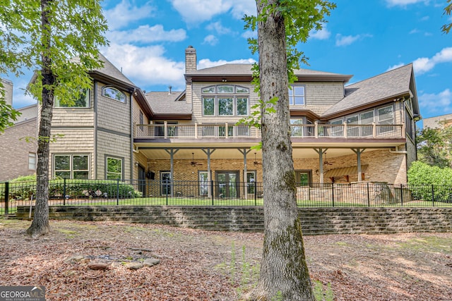 6226 Random Winds Blf, Gainesville, GA 30506 - back of property with a chimney, roof with shingles, a balcony, a fenced backyard, and ceiling fan