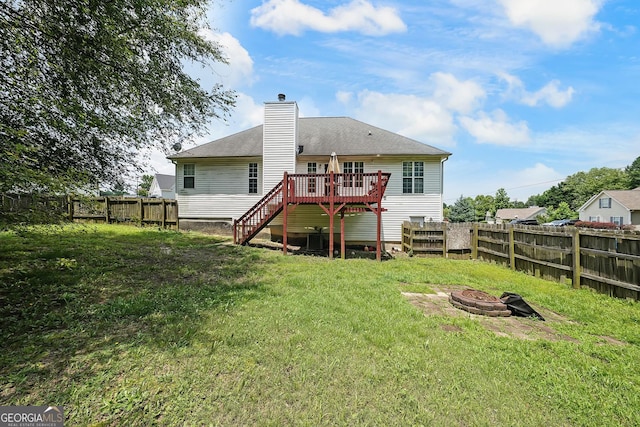 443 Brooks Rd, Dallas, GA 30132 - rear view of property featuring an outdoor fire pit, a wooden deck, a fenced backyard, stairway, and a chimney