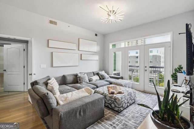 390 17th St NW Unit 6055, Atlanta, GA 30363 - living area with french doors, healthy amount of natural light, and wood finished floors