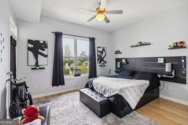 390 17th St NW Unit 6055, Atlanta, GA 30363 - bedroom featuring wood finished floors, ceiling fan, and a view of city