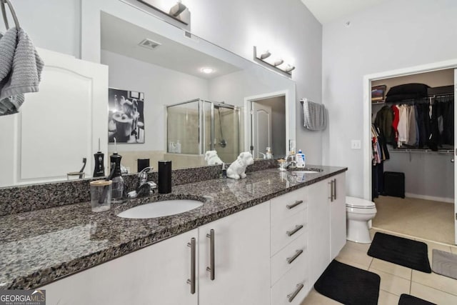 390 17th St NW Unit 6055, Atlanta, GA 30363 - full bath featuring double vanity, a shower stall, tile patterned flooring, and a spacious closet