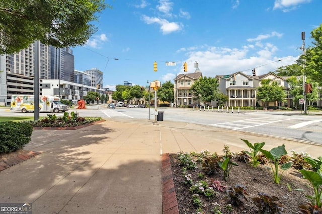 390 17th St NW Unit 6055, Atlanta, GA 30363 - view of asphalt road featuring traffic signs, sidewalks, traffic lights, street lights, and curbs