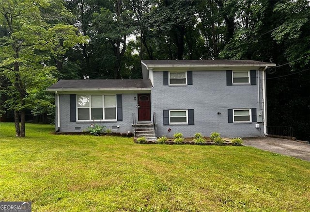 2436 Glenrock Dr, Decatur, GA 30032 - tri-level home featuring brick siding, a front yard, crawl space, and view of wooded area