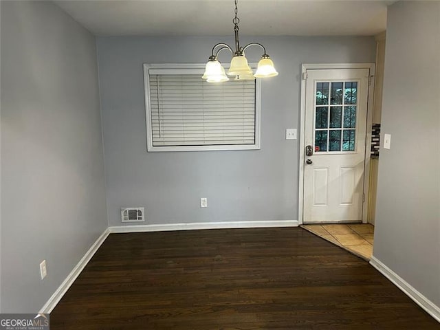 2436 Glenrock Dr, Decatur, GA 30032 - unfurnished dining area featuring a chandelier and wood finished floors