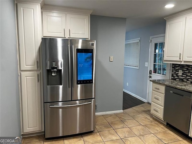 2436 Glenrock Dr, Decatur, GA 30032 - kitchen featuring appliances with stainless steel finishes, decorative backsplash, white cabinets, dark stone countertops, and recessed lighting