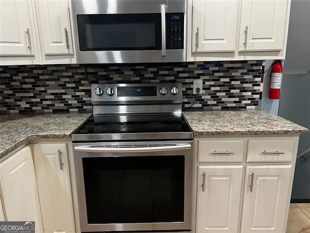 2436 Glenrock Dr, Decatur, GA 30032 - kitchen with appliances with stainless steel finishes, white cabinets, and backsplash