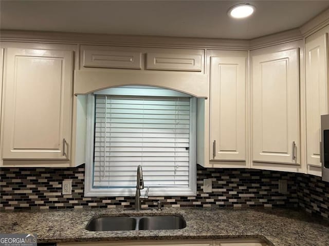 2436 Glenrock Dr, Decatur, GA 30032 - kitchen with decorative backsplash, white cabinetry, and dark stone counters