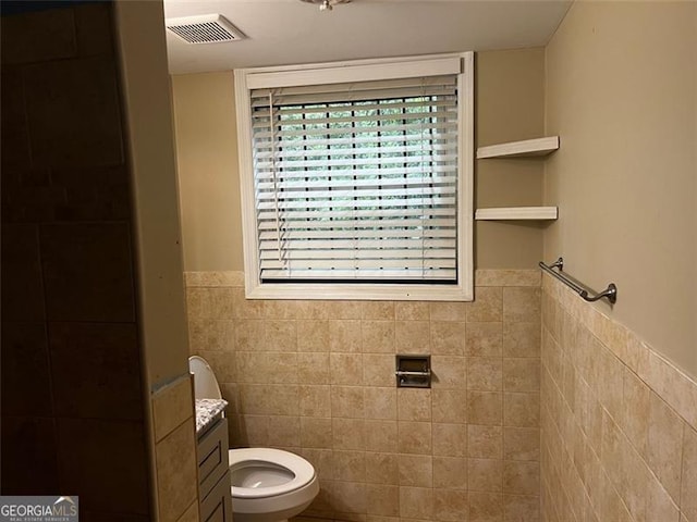 2436 Glenrock Dr, Decatur, GA 30032 - bathroom with tile walls, a wainscoted wall, vanity, and a tile shower