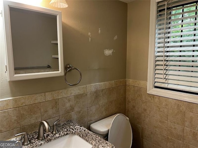 2436 Glenrock Dr, Decatur, GA 30032 - bathroom with tile walls, vanity, and a wainscoted wall