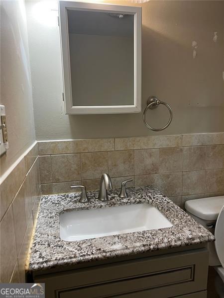 2436 Glenrock Dr, Decatur, GA 30032 - half bathroom featuring vanity and toilet