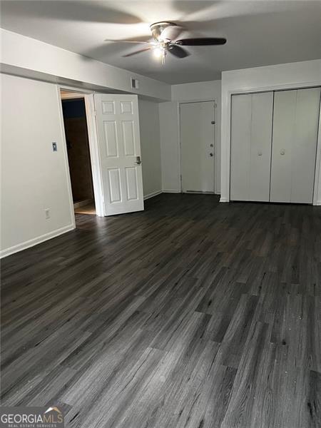 2436 Glenrock Dr, Decatur, GA 30032 - unfurnished bedroom featuring dark wood-style flooring and a ceiling fan