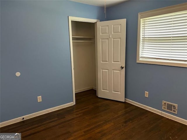 2436 Glenrock Dr, Decatur, GA 30032 - unfurnished bedroom featuring dark wood-type flooring and a closet