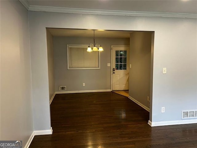 2436 Glenrock Dr, Decatur, GA 30032 - unfurnished dining area with a chandelier, wood finished floors, and ornamental molding