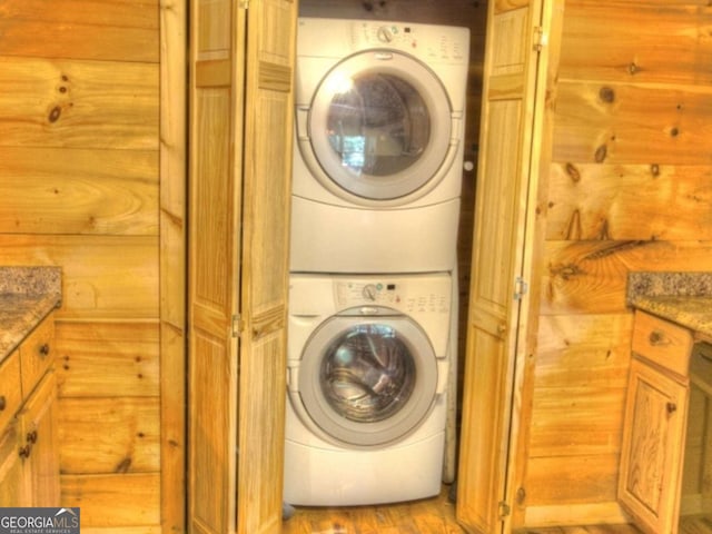 97 Eagles Nest Rd, Sautee Nacoochee, GA 30571 - laundry area with stacked washing machine and dryer, light wood-type flooring, and wood walls