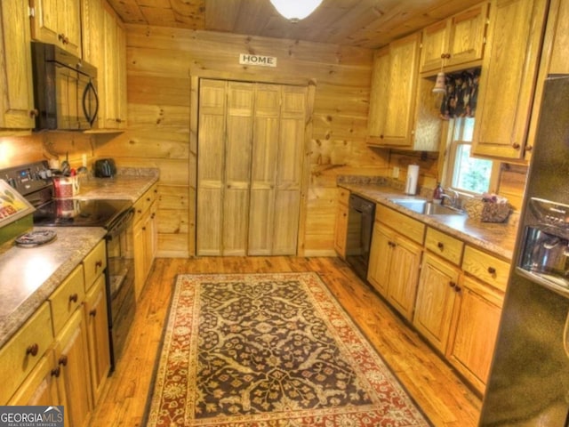 97 Eagles Nest Rd, Sautee Nacoochee, GA 30571 - kitchen with black appliances, light wood-style floors, wooden ceiling, wood walls, and light countertops