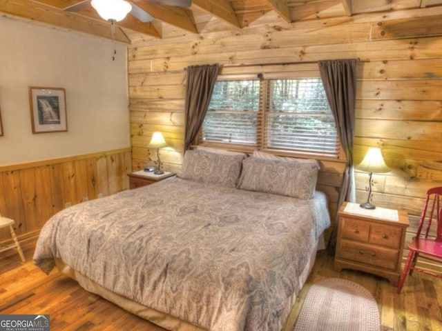 97 Eagles Nest Rd, Sautee Nacoochee, GA 30571 - bedroom featuring wood walls, wood finished floors, beam ceiling, and a wainscoted wall