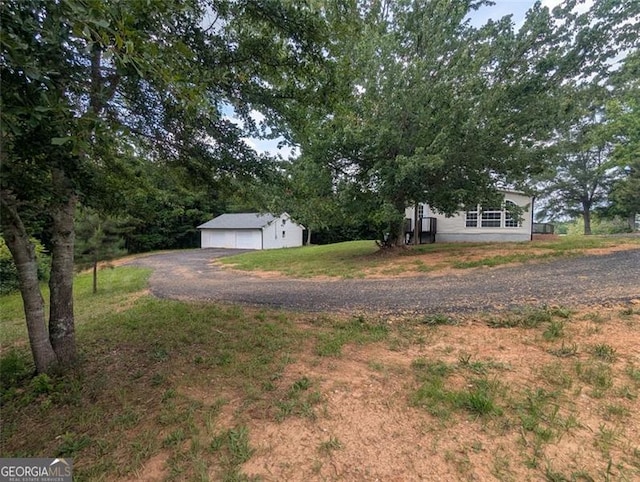 732 Five Points Rd, Buchanan, GA 30113 - view of grassy yard with an outbuilding and a detached garage