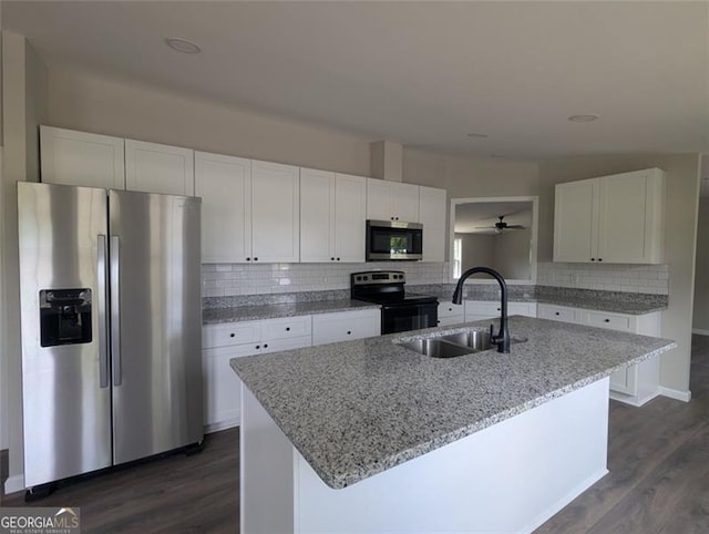 732 Five Points Rd, Buchanan, GA 30113 - kitchen featuring appliances with stainless steel finishes, white cabinets, dark wood-style flooring, and decorative backsplash