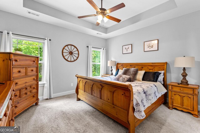 481 Hunter Welch Pkwy, Luthersville, GA 30251 - bedroom featuring light colored carpet, a raised ceiling, multiple windows, and a ceiling fan
