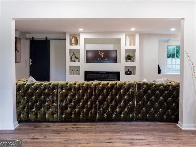 3790 Village, Atlanta, GA 30331 - living room with a glass covered fireplace, wood finished floors, a barn door, and recessed lighting