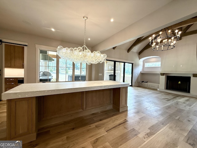 1005 Haddie Way, Alpharetta, GA 30004 - kitchen with a chandelier, light countertops, open floor plan, light wood-style flooring, and pendant lighting