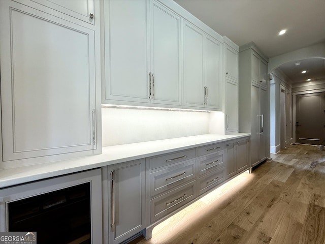 1005 Haddie Way, Alpharetta, GA 30004 - corridor with arched walkways, light wood-type flooring, recessed lighting, and wine cooler