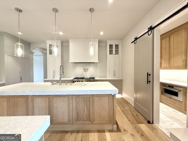 1005 Haddie Way, Alpharetta, GA 30004 - kitchen featuring oven, arched walkways, premium range hood, a barn door, and glass insert cabinets