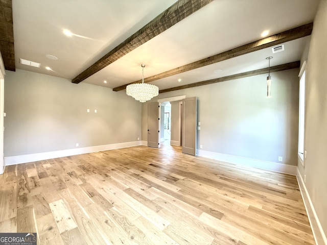1005 Haddie Way, Alpharetta, GA 30004 - empty room featuring beamed ceiling, a chandelier, and light wood-style floors