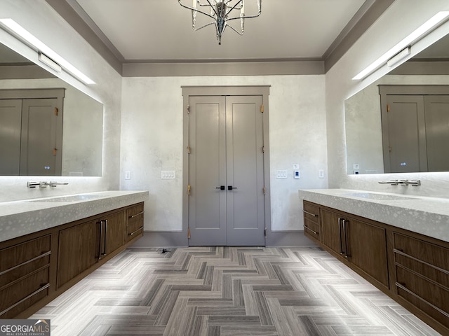 1005 Haddie Way, Alpharetta, GA 30004 - bathroom with two vanities, a chandelier, and ornamental molding