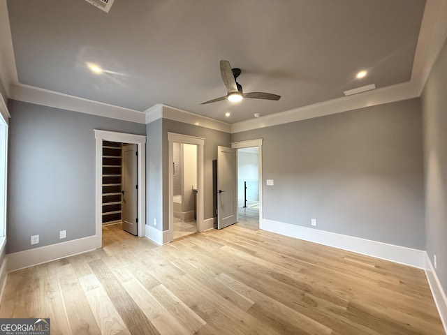 1005 Haddie Way, Alpharetta, GA 30004 - unfurnished bedroom with a spacious closet, ornamental molding, light wood-style flooring, connected bathroom, and a closet