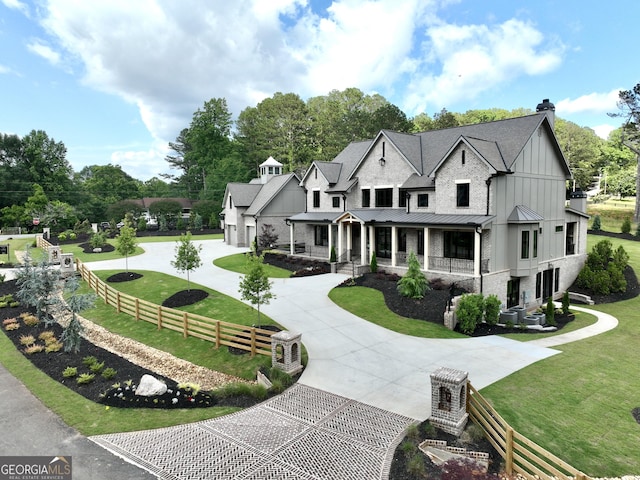 1005 Haddie Way, Alpharetta, GA 30004 - view of front of house featuring curved driveway, a standing seam roof, covered porch, a chimney, and a metal roof
