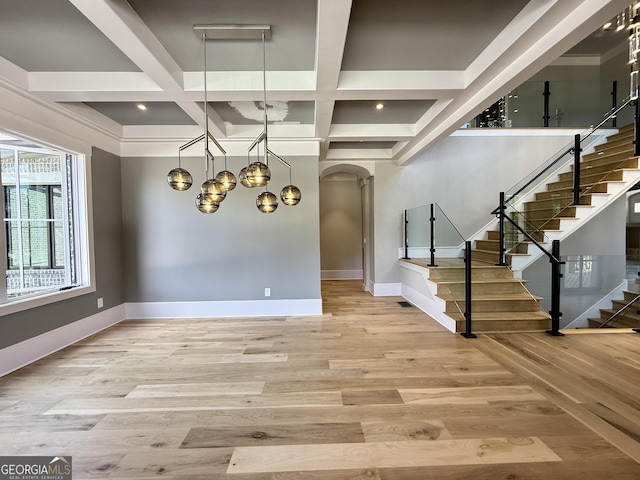 1005 Haddie Way, Alpharetta, GA 30004 - foyer featuring coffered ceiling, arched walkways, wood finished floors, stairway, and beamed ceiling