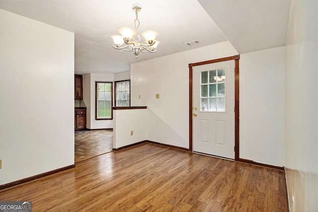 4214 Fiddlers Bnd, Loganville, GA 30052 - empty room featuring a chandelier and wood finished floors