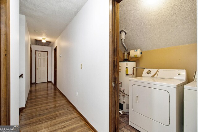 4214 Fiddlers Bnd, Loganville, GA 30052 - laundry area featuring water heater, a textured ceiling, separate washer and dryer, attic access, and wood finished floors