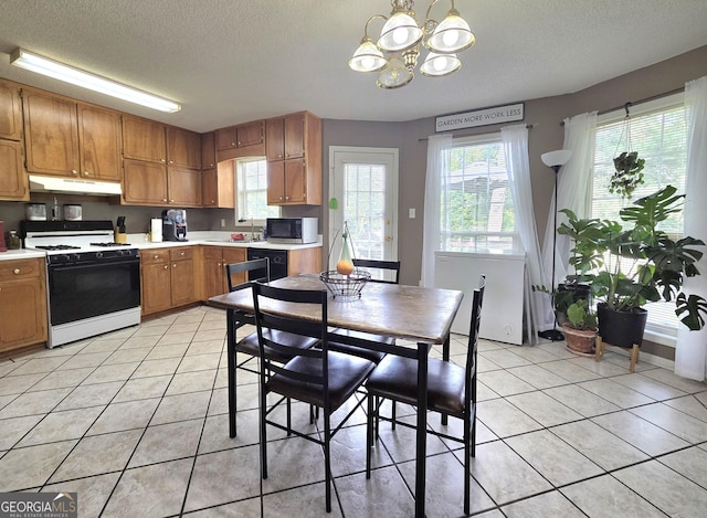 165 Cedar Ridge Rd, Locust Grove, GA 30248 - dining space featuring a chandelier, a textured ceiling, and light tile patterned floors