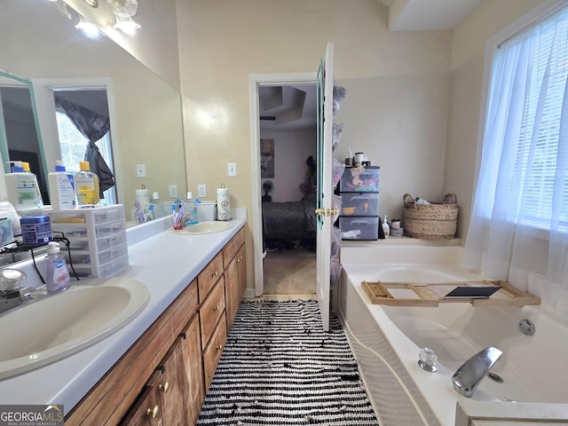 165 Cedar Ridge Rd, Locust Grove, GA 30248 - ensuite bathroom with a garden tub, healthy amount of natural light, and double vanity