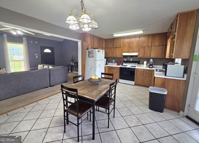 165 Cedar Ridge Rd, Locust Grove, GA 30248 - dining area featuring a ceiling fan, a chandelier, and light tile patterned floors