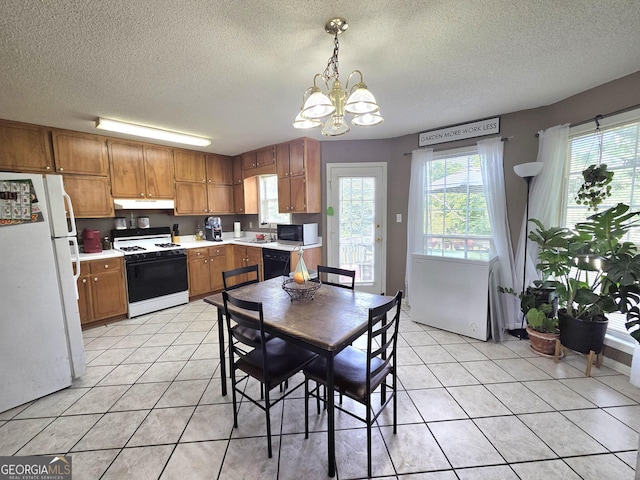 165 Cedar Ridge Rd, Locust Grove, GA 30248 - kitchen featuring black appliances, under cabinet range hood, a chandelier, light countertops, and a textured ceiling