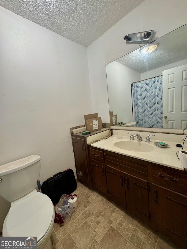 3411 Lake Ridge Pl, Gainesville, GA 30506 - bathroom with a textured ceiling, vanity, stone finish flooring, and curtained shower