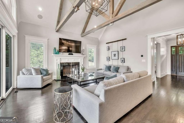 481 Meadow Lake Ter, Hoschton, GA 30548 - living area featuring dark wood-style flooring, a chandelier, healthy amount of natural light, a fireplace, and beam ceiling
