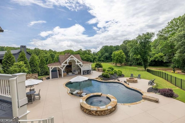 481 Meadow Lake Ter, Hoschton, GA 30548 - view of pool featuring an outdoor fire pit, an exterior structure, a patio, an outdoor structure, and a pool with connected hot tub