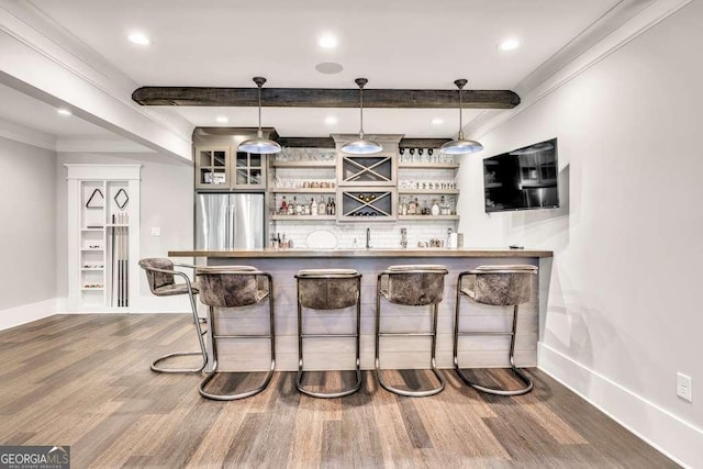 481 Meadow Lake Ter, Hoschton, GA 30548 - indoor wet bar with freestanding refrigerator, wood finished floors, beam ceiling, pendant lighting, and crown molding